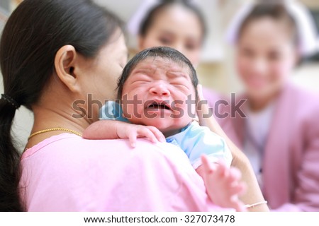 Mother and  her newborn baby with nurses,Happy cheerful moment.