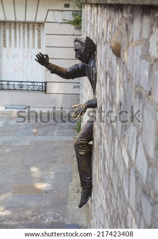 Paris, France-July 15, Marcel Ayme monument in Montmartre-man who walked through walls, July 15.2013 in Paris