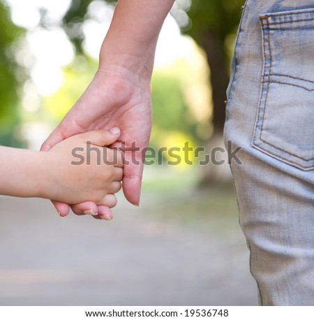 mother hold son  by the hand