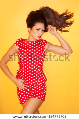 Hot woman wearing red polka dots dress with black stiletto
