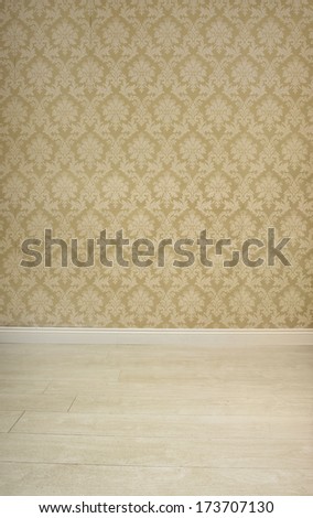 Empty room with vintage beige wallpaper in an arabesque pattern with space for product placement in a retro background