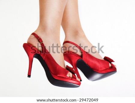 Red high heels isolated against a white background