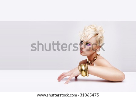 pretty blonde model with gold charm bracelet retro hairstyle and color makeup