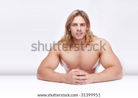 Athletic sexy male body builder with the blonde long hair. gladiator