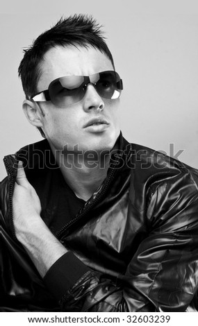 fashion male brunette portrait wearing black jacket and sunglasses