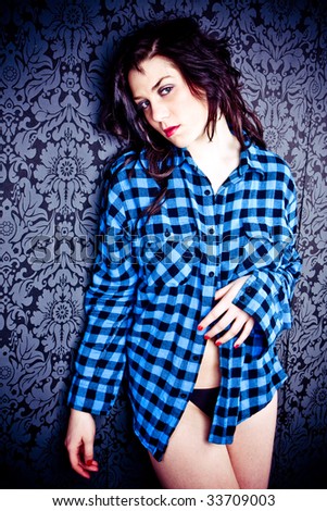 sexy young woman wearing blue shirt on nice wallpaper background