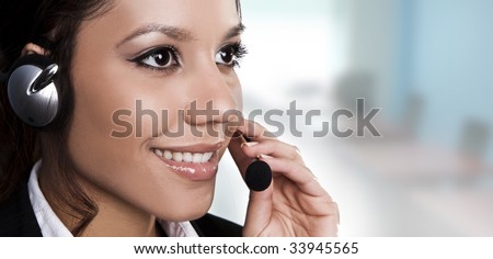 Isolated portrait of a beautiful help desk or support line operator answering a call.