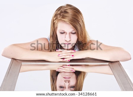 young woman looking into a mirror