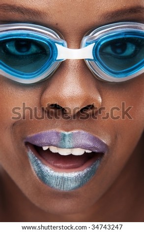 african or american dark skin beauty with violet lips and swimming glasses