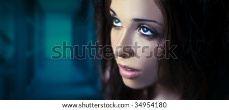 Fantasy glamour portrait of a young beauty with blue eyes