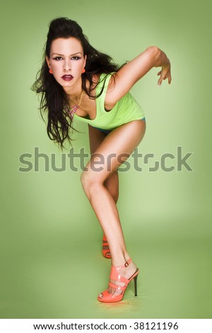 glamour fashion woman with a green lingerie and top on the green background
