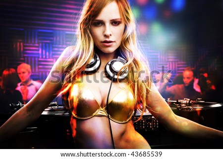 Beautiful DJ girl standing in the front of the decks