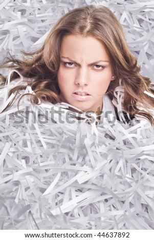 Young Businesswoman covered by shredded papers