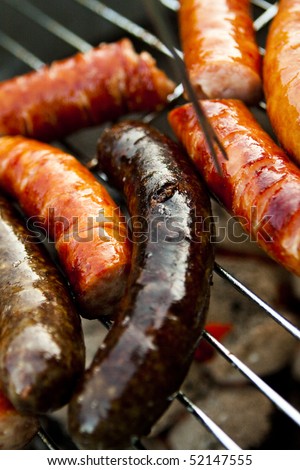 Delicious grilled sausages and black puddings  closeup