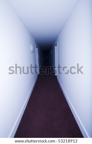 Long hotel corridor with red carpet