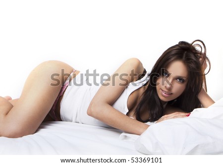 stock photo Photo of the brunette sexy woman pampering on a white bed