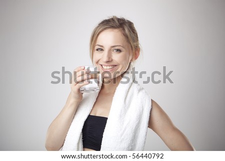 Woman Drinking Water wearing sportswear and towel