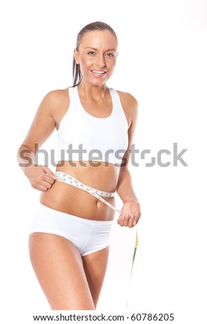 Young beautiful fit woman with measure tape on white