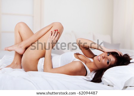 stock photo sexy brunette wearing sexy pyjama on white bed