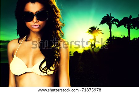 sexy brunette woman on the palm beach at sunset party