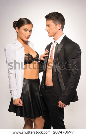 Black and White Fashion Photo Shoot. Two Sexy Young Couple Showing Perfect Abs.