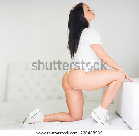 Pretty Young Woman in White Shirt, Underwear and Sneakers Kneeling Pose Showing Sexy Ass.