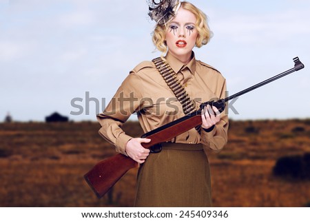 Stylish Young Pretty Girl Scout Carrying Gun While at the Field