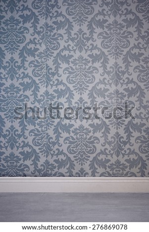 Gray residential interior with wall covered by wallpaper with seamless floral damask pattern and empty floor