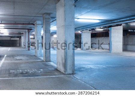 Dark parking garage industrial room interior with blue light