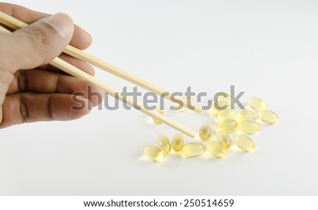 Chop stick picking a fish oil