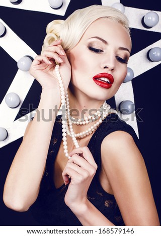 sexy girl with blond hair with pearls in retro style