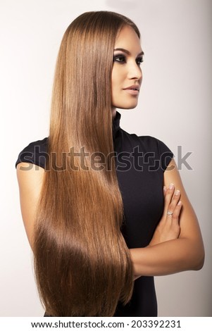 fashion studio photo of sexy beautiful woman with long straight dark hair in elegant black dress