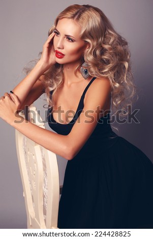 fashion studio photo of sexy beautiful woman with retro hairstyle wearing elegant black dress and accessories