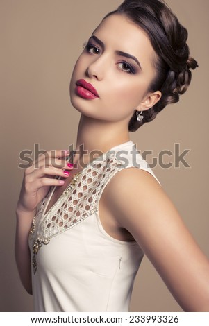 fashion studio photo of beautiful girl with elegant hairstyle and evening makeup