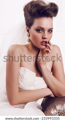 fashion interior photo of beautiful glamour bride with retro hairstyle in elegant wedding dress