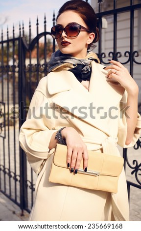 fashion outdoor photo of beautiful young woman looking like elegant lady,wearing white wool coat and accessories