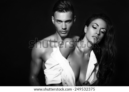 black and white fashion photo of sexy impassioned couple posing in studio