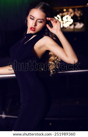 fashion indoor photo of beautiful sensual woman with dark hair in elegant clothes posing in luxury restaurant