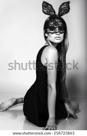 black and white fashion photo of beautiful sexy Easter bunny girl with luxurious straight hair