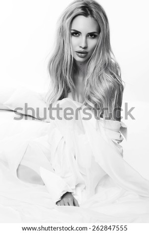 black and white fashion photo of sexy beautiful woman with blond hair posing in studio