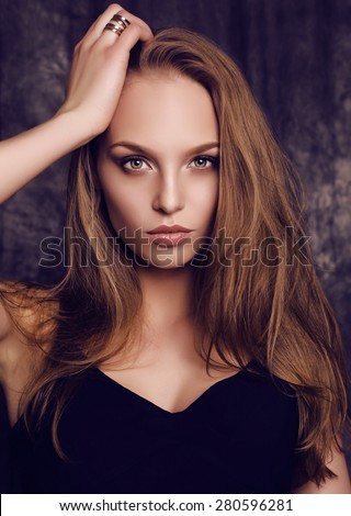 fashion studio portrait of beautiful young woman with dark hair and green eyes