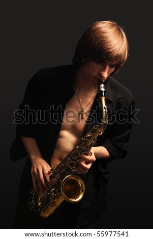 Man with a sax musical instrument on tne black background
