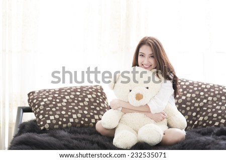 Portrait of pretty young woman with teddy bear