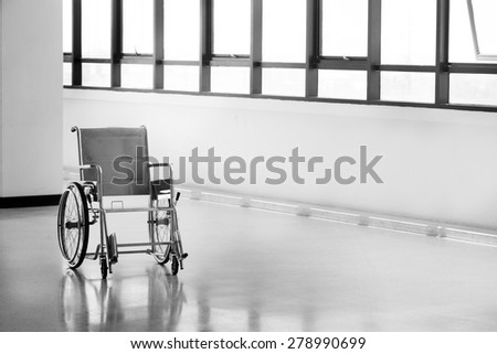 Empty wheelchair parked in hospital hallway