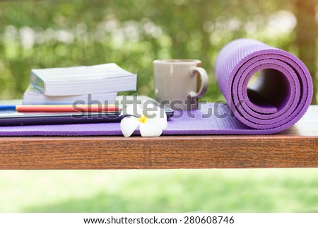 yoga mat and a cup of coffee on wood table