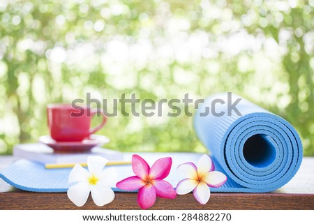 blue yoga Mat and a beautiful flowers