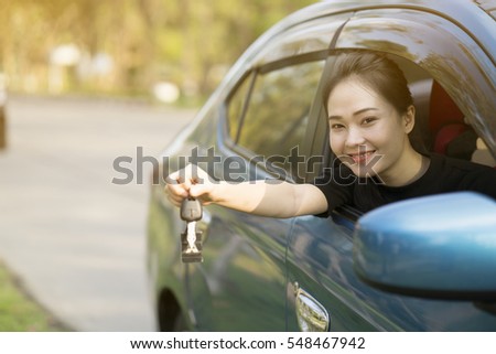 young happy woman in car with sunlight