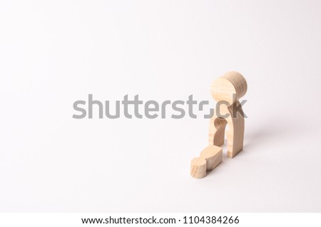 A wooden figure of a woman with a void from which a child fell. The concept of the loss of a child, abortion of pregnancy, miscarriage. mother lost her child. Deprivation of parental rights.