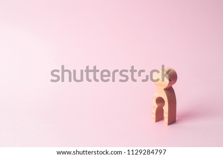 A wooden figure of a woman with a void inside in the shape of a child. The concept of the loss of child, abortion of pregnancy, miscarriage. Infertility in women. unhappy mother lost her child