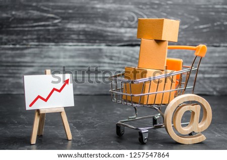 A supermarket cart loaded with lots of boxes and a red up arrow. Online sales and e-commerce, product and brand promotion. concept of increasing sales, increasing consumer ability, welfare of society